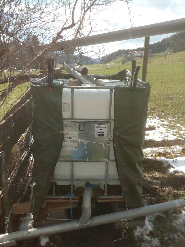Wassertank mit grüner Gewebeplane umwickelt